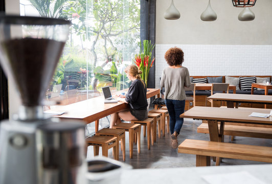 Woman walking through a cafe