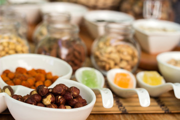 Various piles of mixed gummy candy and nuts 