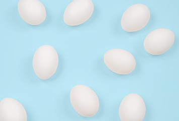 White egg. Raw eggs on pastel blue background.