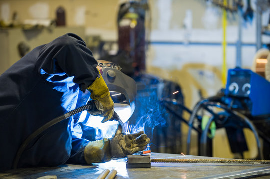 Welder in a blacksmith shop