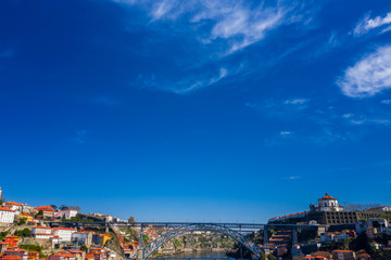 Fototapeta na wymiar Porto Cityscape with Dom Luis I Bridge over Douro River and medieval Ribeira district at day time, Portugal