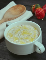 Healthy and tasty breakfast. Oatmeal with strawberries on a black wooden table. close-up. rustic