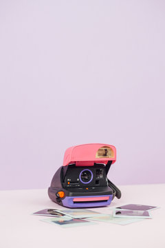 Polaroid camera on pink background