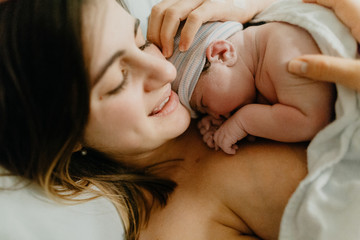 Close up of mother holding newborn baby