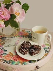 morning coffee with cookies on a decorated handmade tray.Cut roses. All on light background. Top view