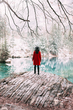 Young woman exploring turquoise lake in Switzerland