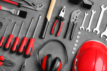 Flat lay composition with different construction tools on grey background