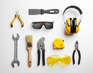 Flat lay composition with different construction tools on white background