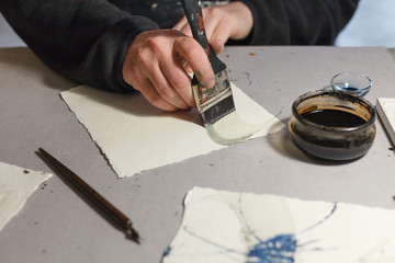A calligrapher creating artworks in his workshop