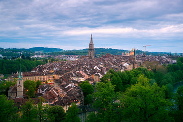 Aerial view of the Bern old town with the Aare river flowing around the town at night in Bern, Switzerland.