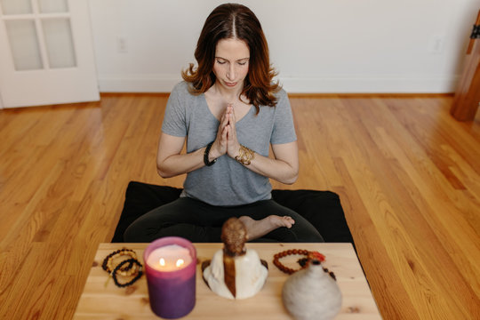 Beautiful woman practicing meditation at home