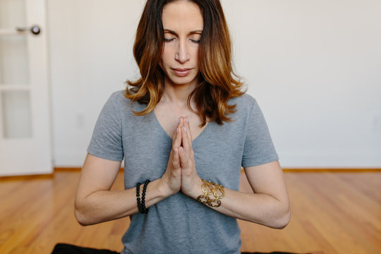 Beautiful woman practicing meditation at home