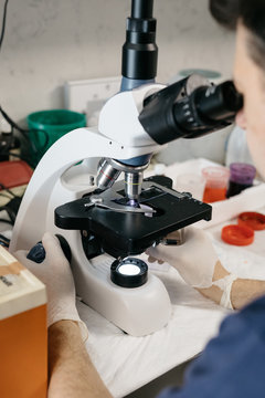 Medic using microscope in clinic
