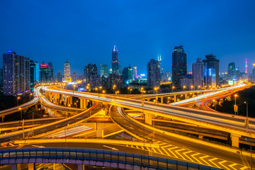 Fototapeta na wymiar Shanghai elevated road junction and interchange overpass at night in China.