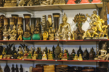 Various Thai Buddha statuettes and souvenirs for sale in local Bang Niang Night Market, Khao Lak, Thailand.