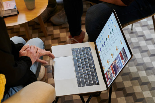 Person using laptop to find cheap tickets.