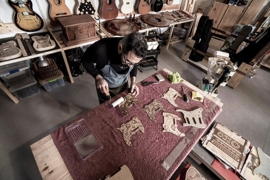 Guitar luthier working in his workshop