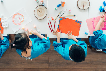 Preschool kids painting in classroom