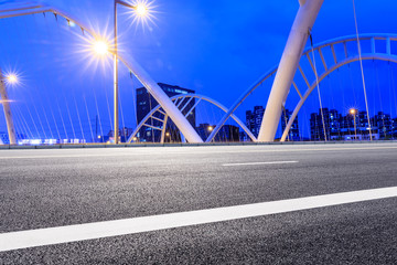 Empty asphalt road and bridge construction in shanghai at night