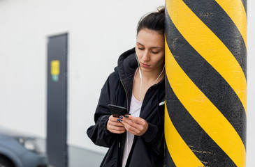 Female jogger having a break to change msuci playlist