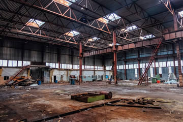 Abandoned industrial building with old rusty bridge crane and metal constructions