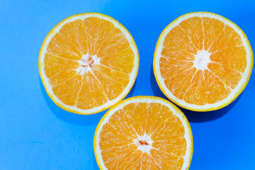 Orange halves on colorful background