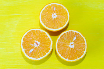 Fototapeta na wymiar Orange halves on colorful background