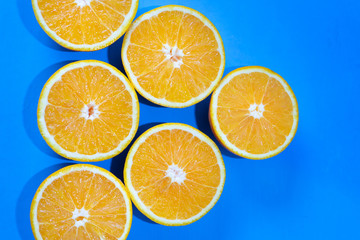 Orange halves on colorful background