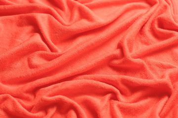 Modern fabric background or mock up with space for text. Texture of cloth in coral color of the year 2019