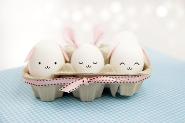 Easter eggs with cute bunny faces and ears.