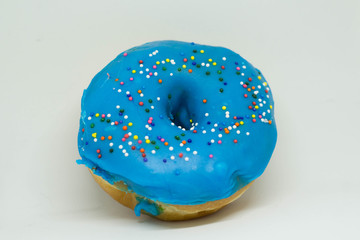 blue doughnut with sprinkles isolated on white background