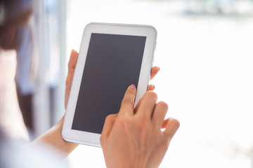 Cute child is using digital tablet.