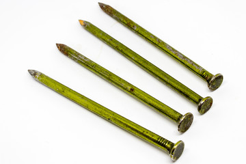 Fototapeta premium four old metal rusty nails closeup with white background