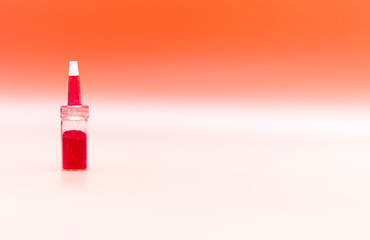 Bottles with multi-colored spangles and colored fillings for decoration, festive decoration on pink background