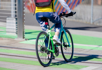 Elegant woman with backpack loves to ride bike taking care of her health