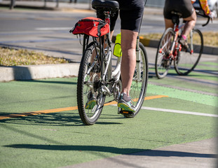Enthusiasts ride bicycles one after another along the cycle path