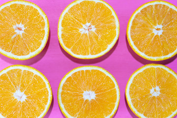 Orange halves on colorful background