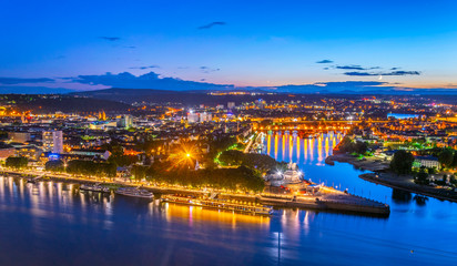 Night aerial view of confluence of Rhein and Mosel rivers in Koblenz, Germany