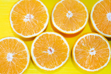 Orange halves on colorful background