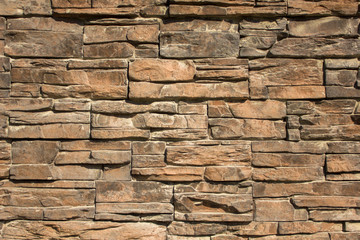 gray yellow wall of stone tiles of various sizes and shapes. rough surface texture