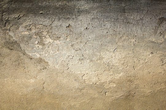 old gray white black shabby concrete wall with severe damage and scratches. rough surface texture