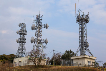 Broadcast relay station antennas at rising. Telecommunications towers.