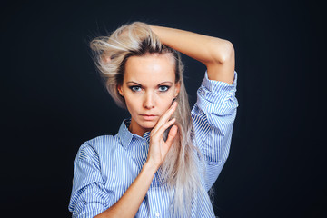 Attractive girl with blond hair posing, gesturing hands and face.