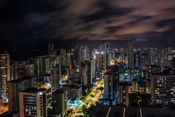 Fototapeta premium Recife at night with airplane in the background