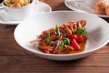 Chicken shish kebabs with green salad. Selective focus 