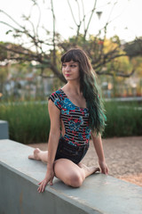 Naklejka premium A cute girl dancing in the park