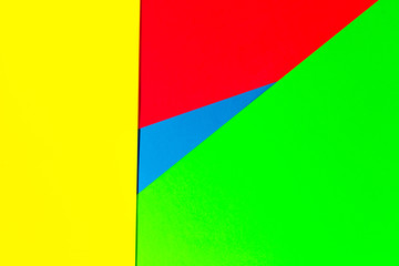 Vibrant multicolor background from cardboard of different colors. Color paper for background. Colorful abstract geometric shapes. Minimalist design for minimal background. Colorful background.