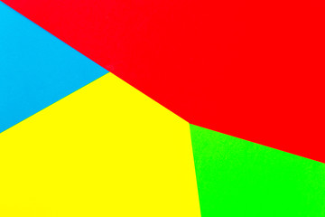 Vibrant multicolor background from cardboard of different colors. Color paper for background. Colorful abstract geometric shapes. Minimalist design for minimal background. Colorful background.