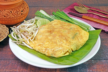 Thai food : Stir-Fried rice noodle (Pad Thai, or Phad Thai) wrapped in egg, commonly served as a street food and at most restaurants in Thailand. Popular Thai cuisine.