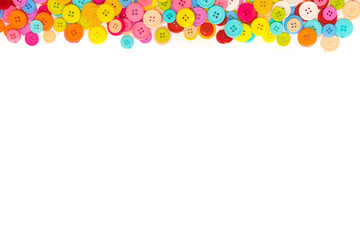 Colorful Sewing buttons on white background. Top view. Free space. Border